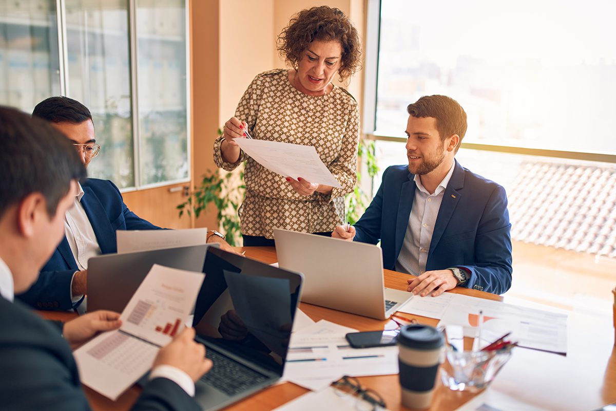 A business lawyer’s meeting with laptops and graphs.