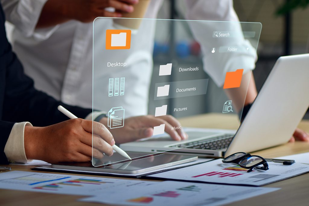 A person organizes files on their laptop.