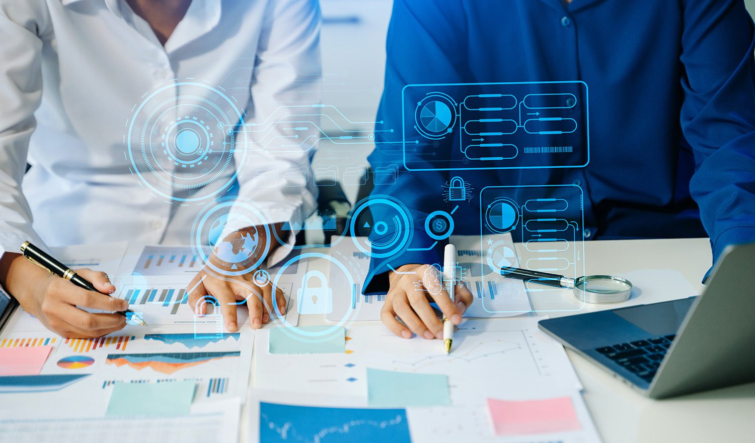 A pair of businesswomen working at a desk with dozens of graphs, with digital symbols overlaid
