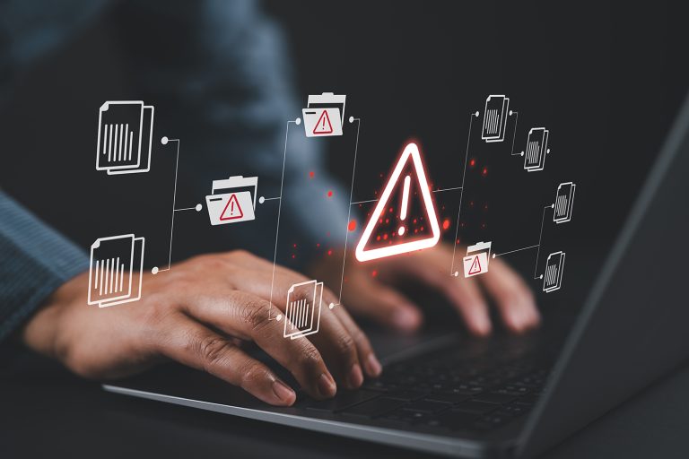 A closeup of a person’s hands with warning symbols displayed over them, representing zero-day exploits.